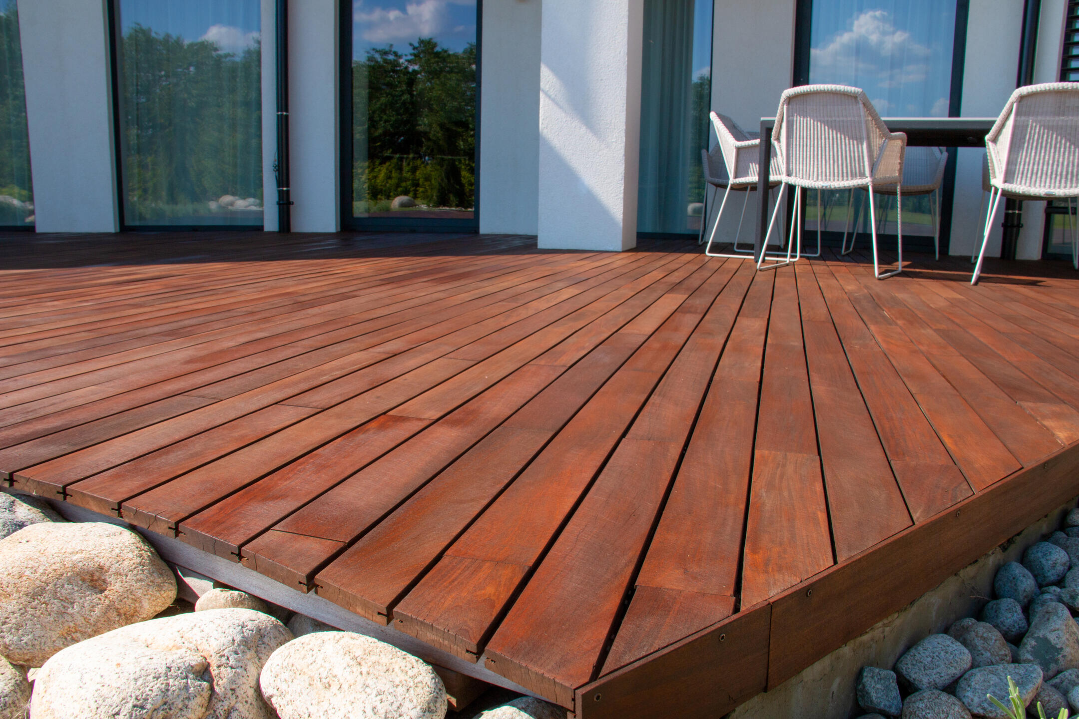 best decking material-close up of a new deck after being installed just off a home