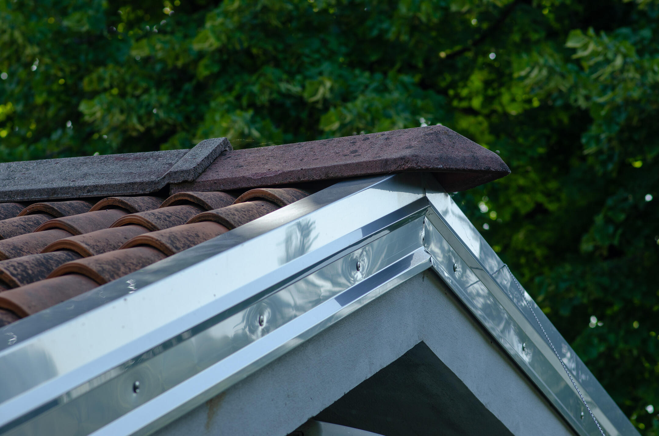 roof flashing-metallic flashing on a tiled roof