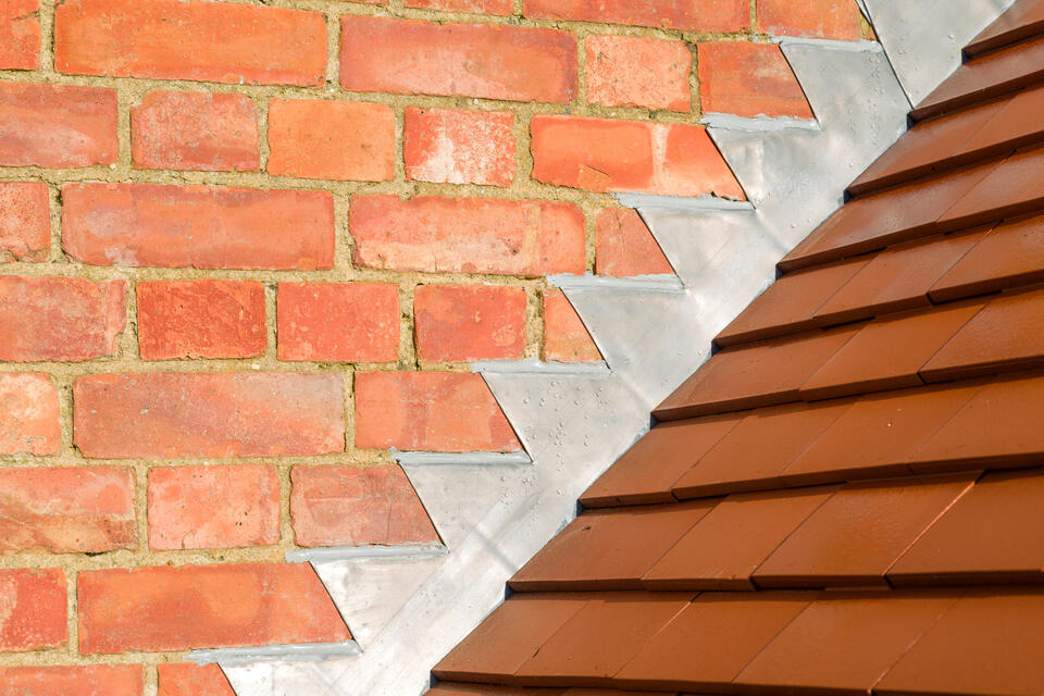 roof flashing-step flashing between brick house and roofing material